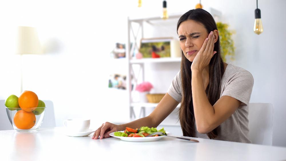 woman in pain eating | dentist in reservoir