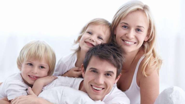 family of four hugging | dentist reservoir VIC