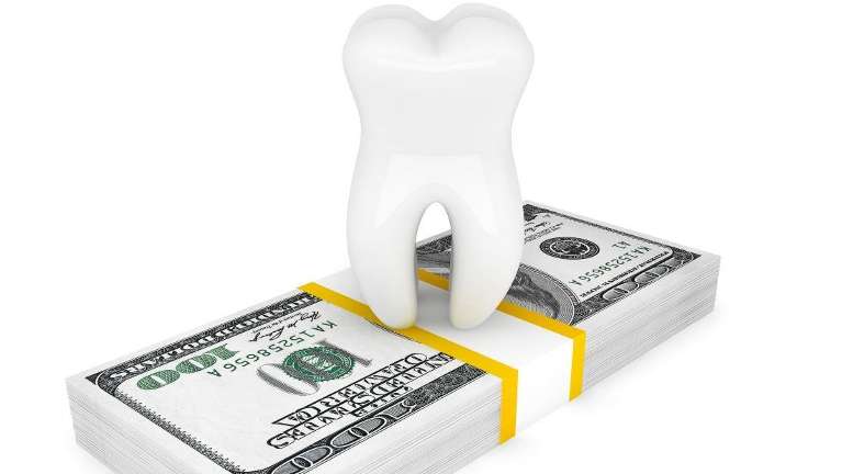 Tooth image on stack of money | Reservoir Dentist
