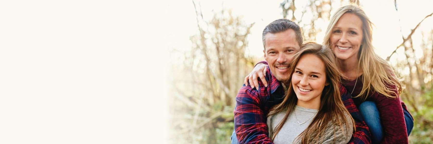 family of three hugging | dentist near me